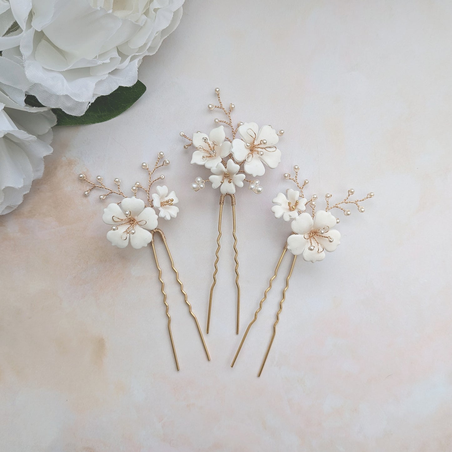 Statement hand sculpted clay floral hair pins for brides designed & handmade by Susie Warner.