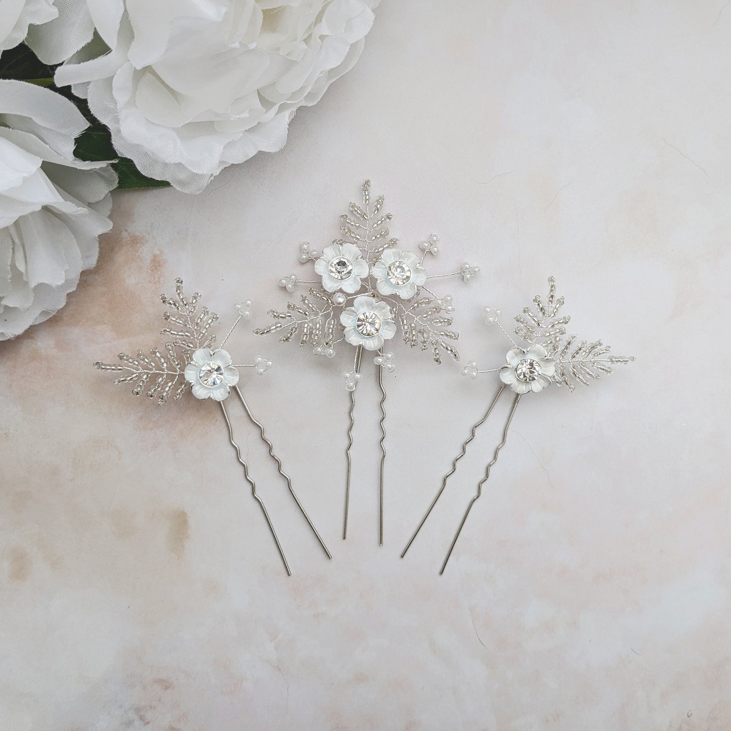 Statement hand painted white floral hair pins for brides designed & handmade by susie warner.