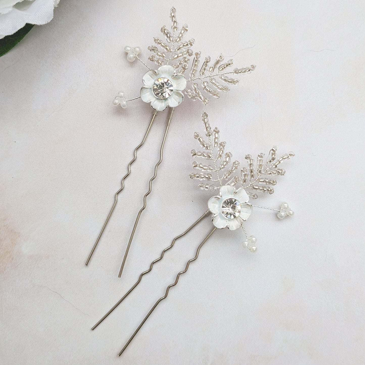 Small white floral hair pin detail designed & handmade by Susie Warner.