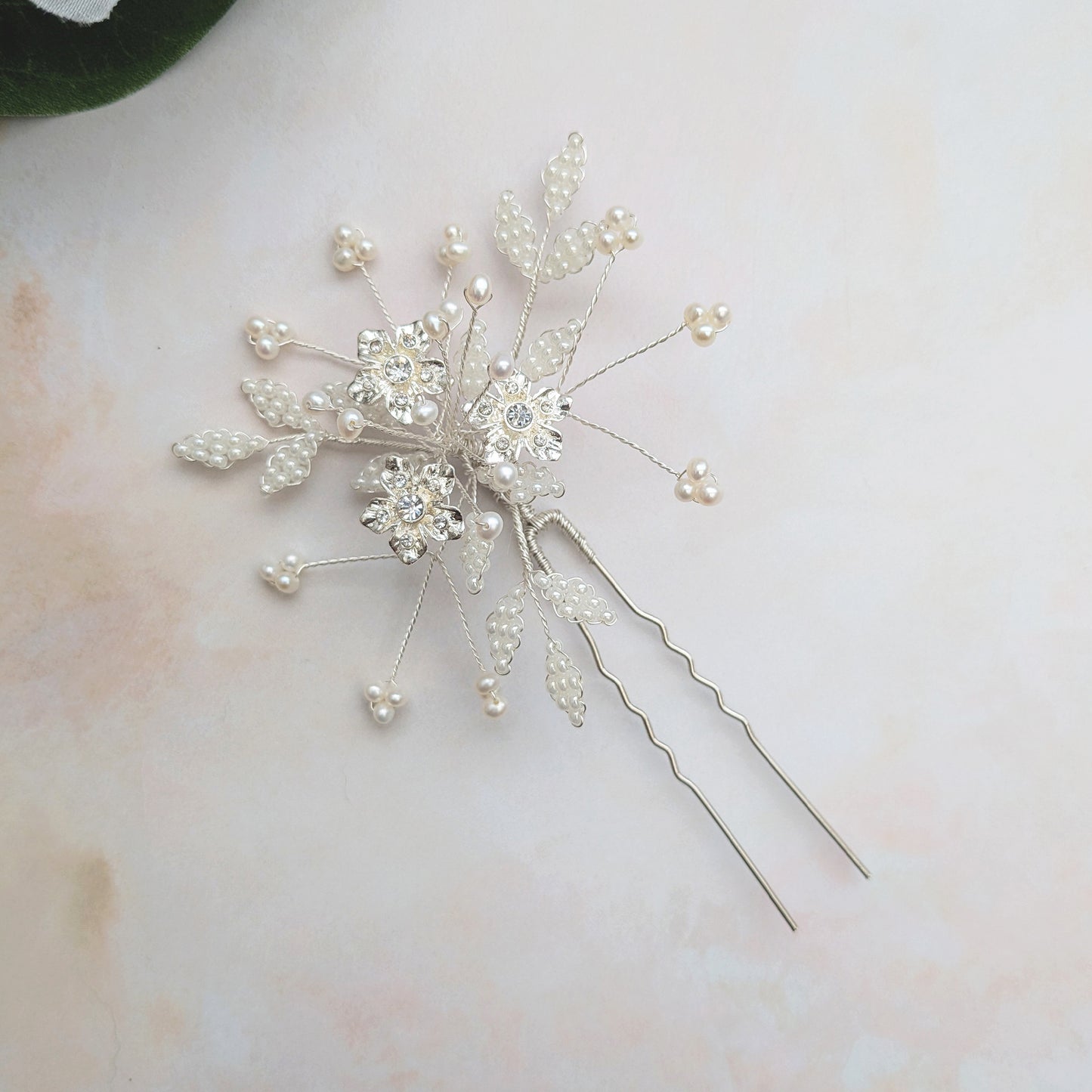 Statement floral hair pins for brides with crystal & pearl leaves designed & handmade by Susie Warner.