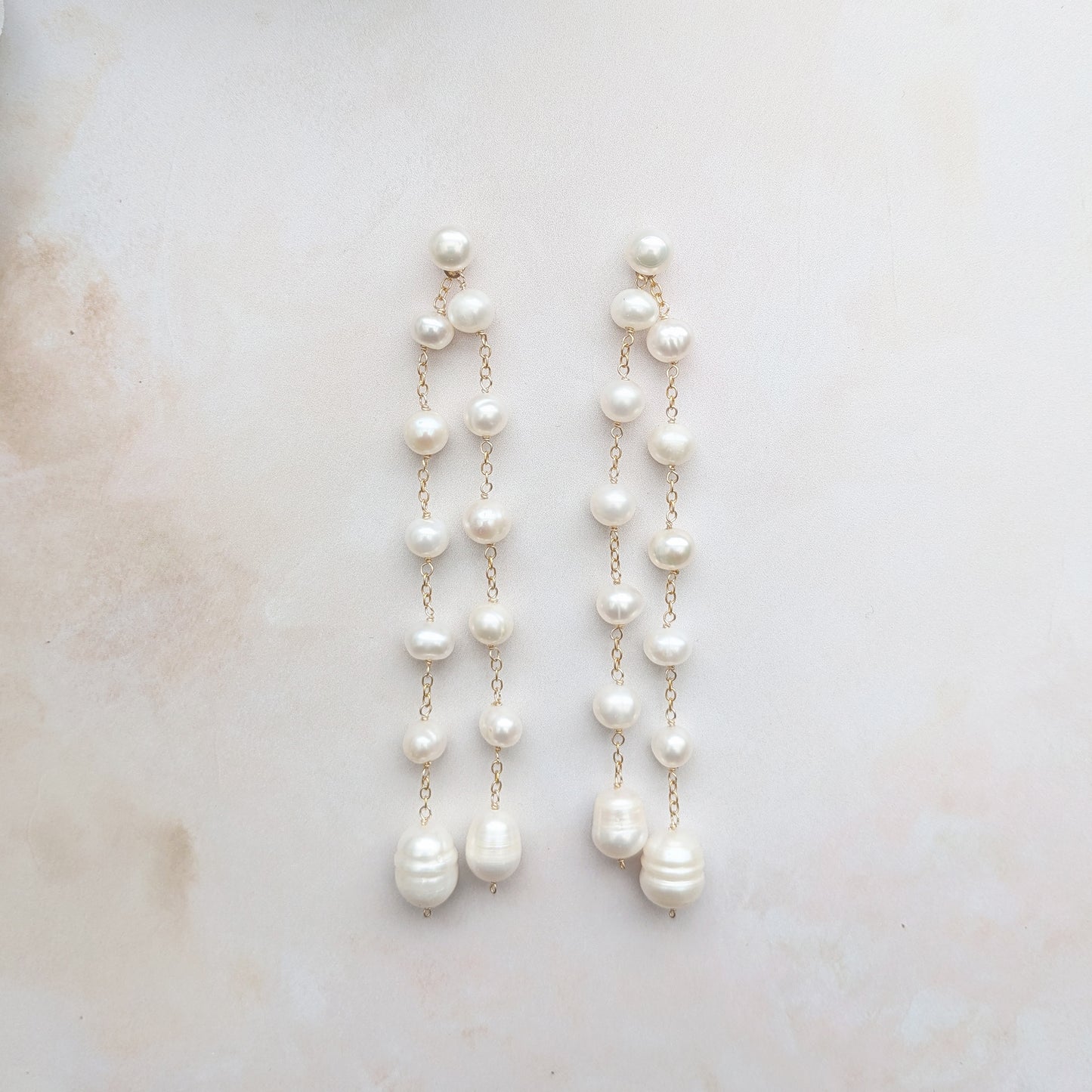 Front view of statement pearl double drop earrings with front and back drops for brides designed & handmade by Susie Warner.