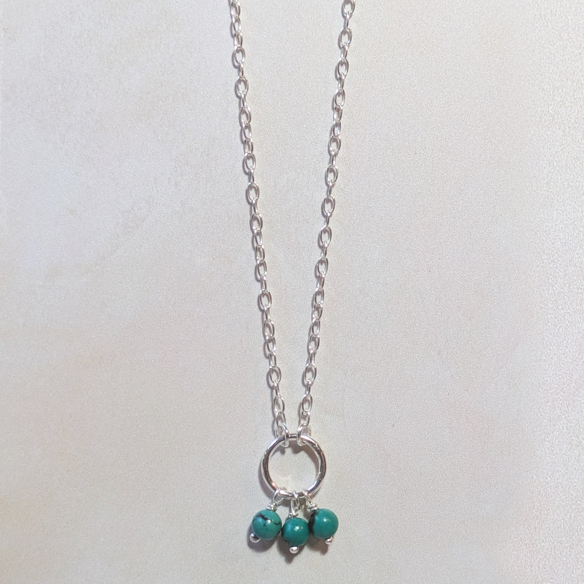 Necklace with Turquoise beads on a white background.