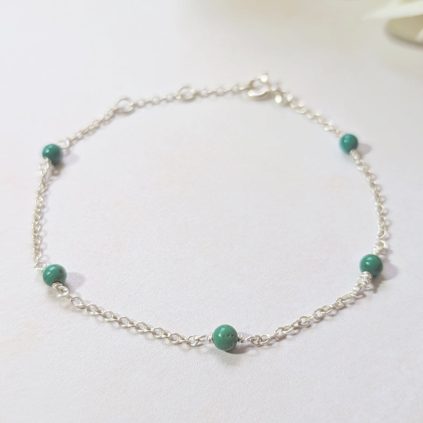 Silver stationed bracelet with natural Arizona Turquoise beads on a white background.