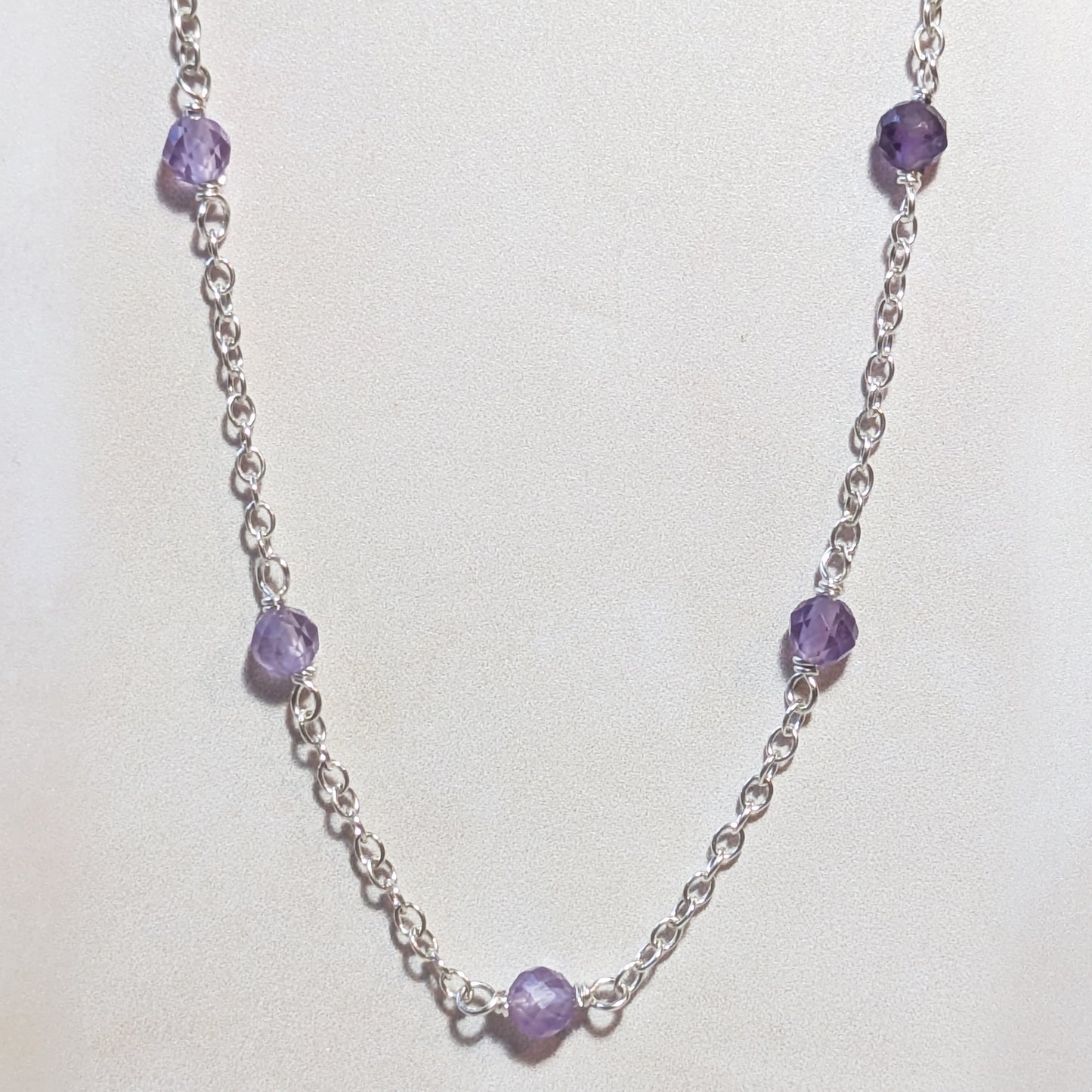Necklace with real Amethyst  gemstone beads on a white background.