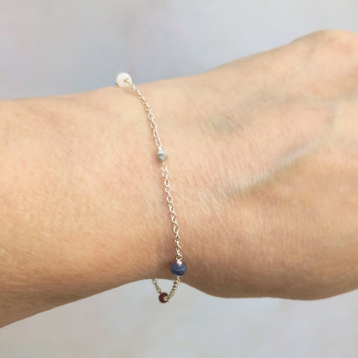 Personalised sterling silver family birthstone bracelet  featuring natural ethically sourced gemstone beads shown on a real life model.