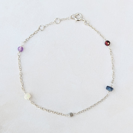 Personalised sterling silver family birthstone bracelet  featuring natural ethically sourced gemstone beads shown on a white background.