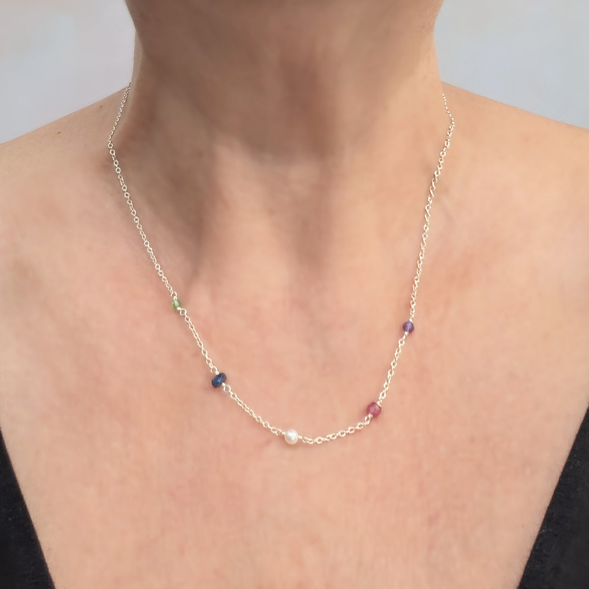 Personalised sterling silver family birthstone necklace  featuring natural ethically sourced gemstone beads shown on a real life model.