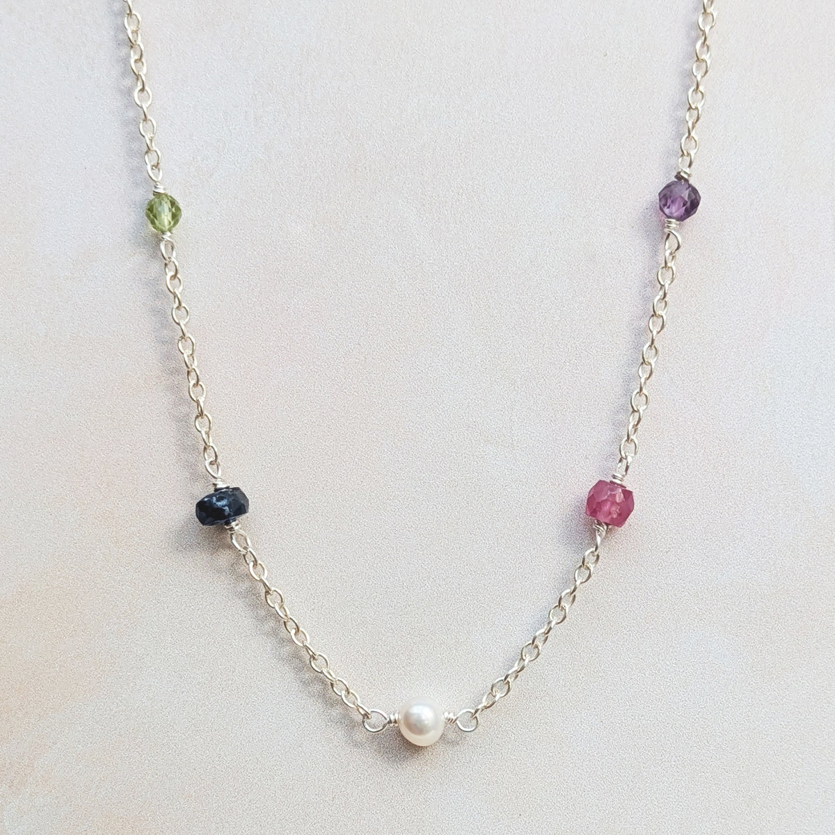 Personalised sterling silver family birthstone necklace  featuring natural ethically sourced gemstone beads shown on a white background.