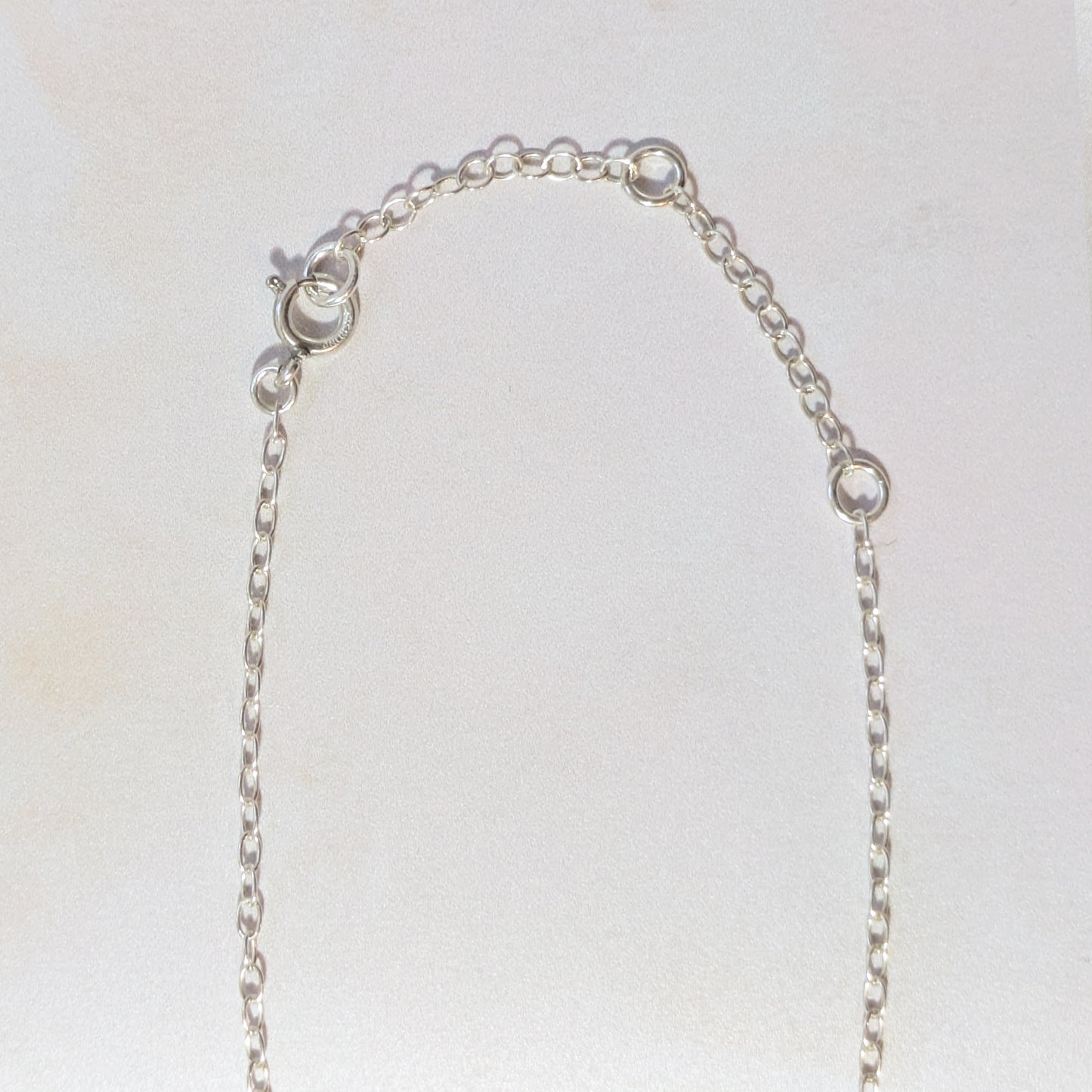 Silver 16"-18" extension chain on a light grey background.