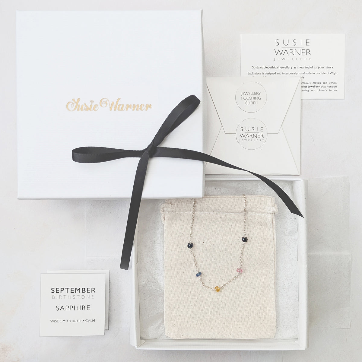 Luxury sustainable gift packaging with cotton travel pouch and gemstone information booklet