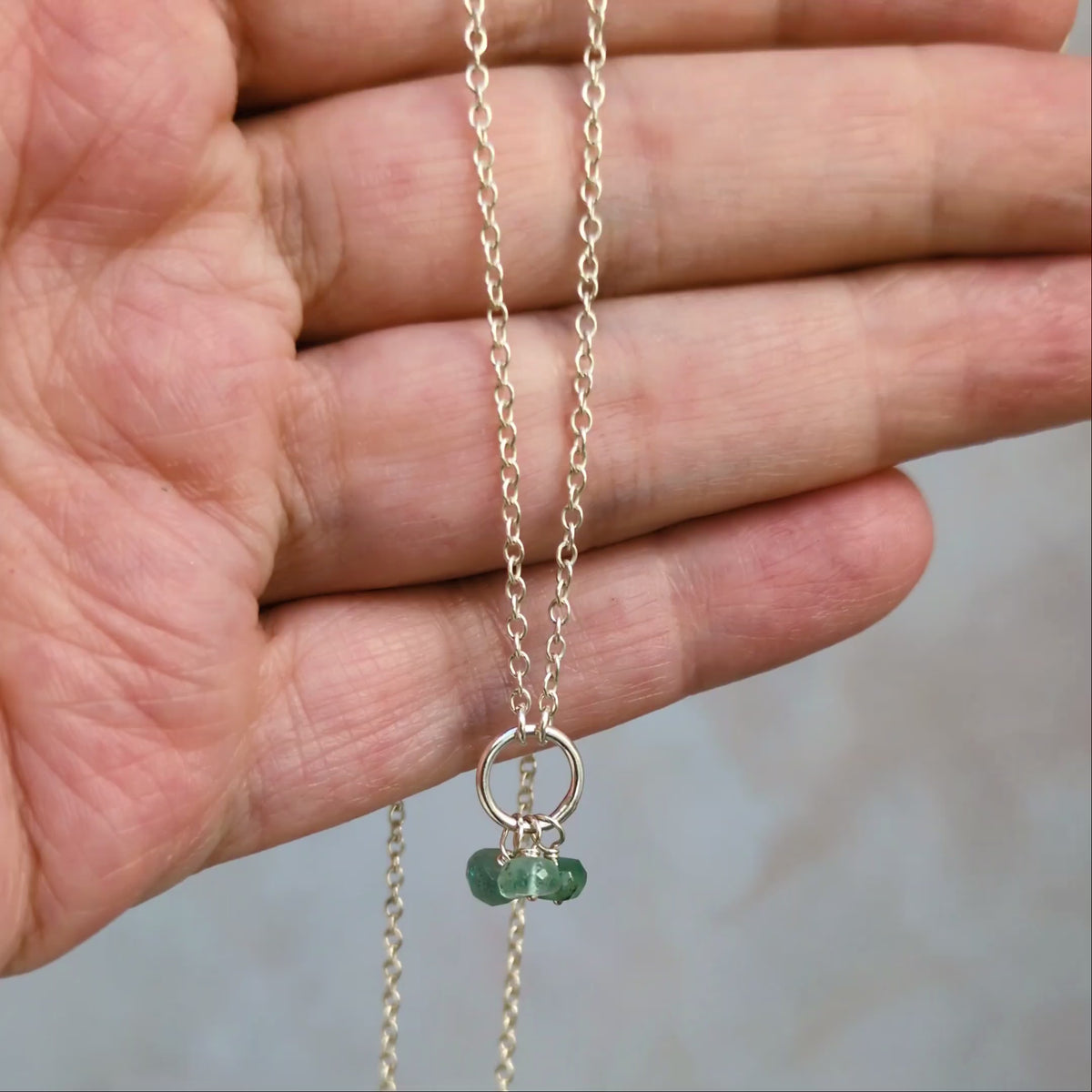 Video showing birthstone circle necklace in the hand.